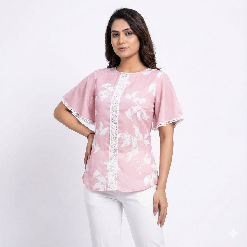 Woman wearing a pink blouse with white floral patterns on a white background