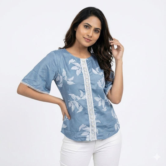 Woman wearing a blue floral top with white accents on a light gray background